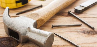 a hammer and a pair of pliers on a table.