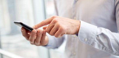 a man holding a smart phone in his hand.