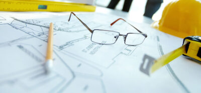 a pair of glasses sitting on top of a blueprint.
